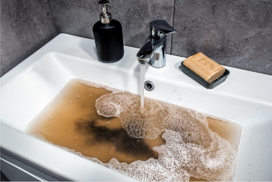 clogged sink with dirty water